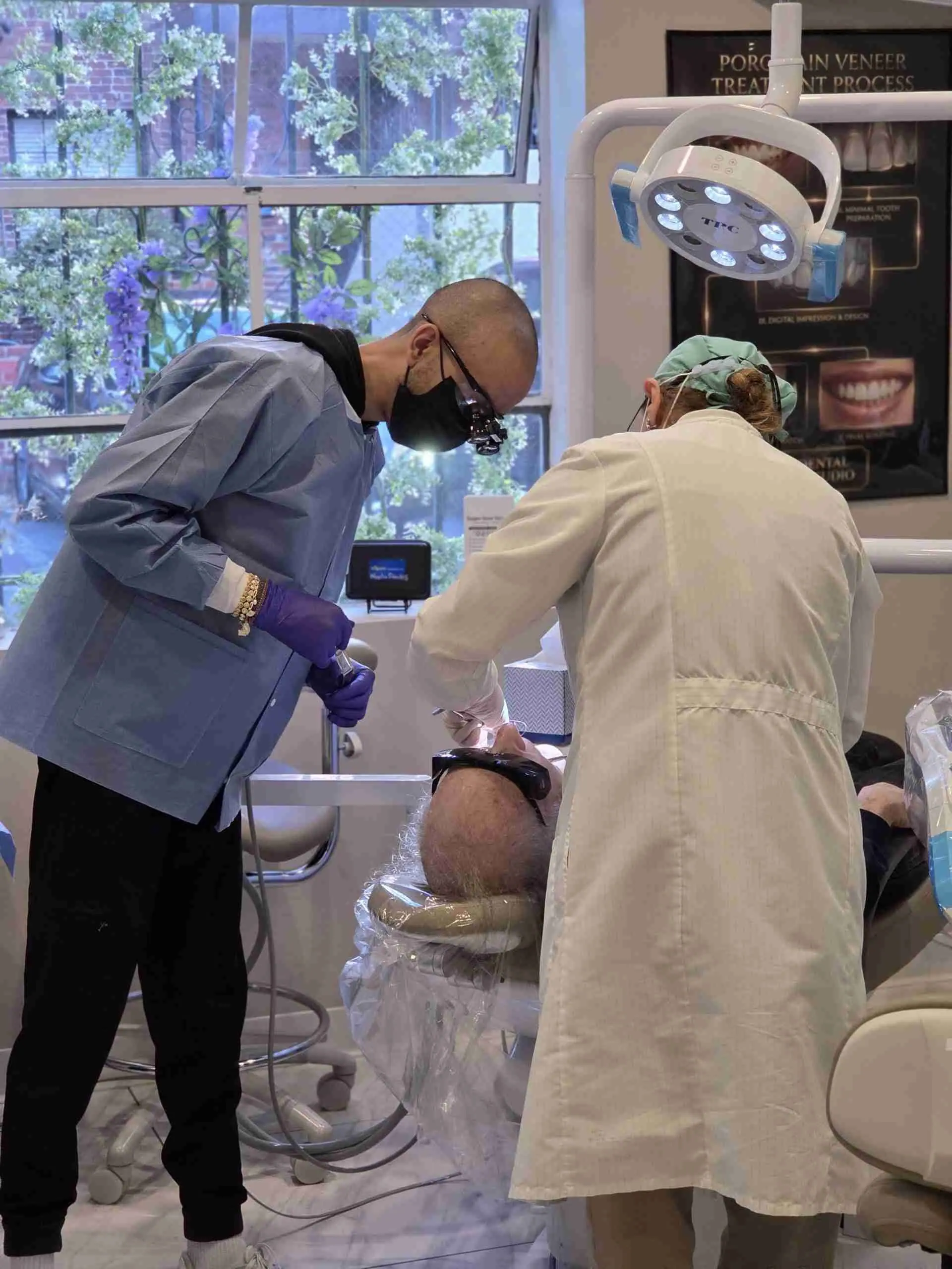 Two clinicians treating a patient in a treatment room at the Bedford Drive office