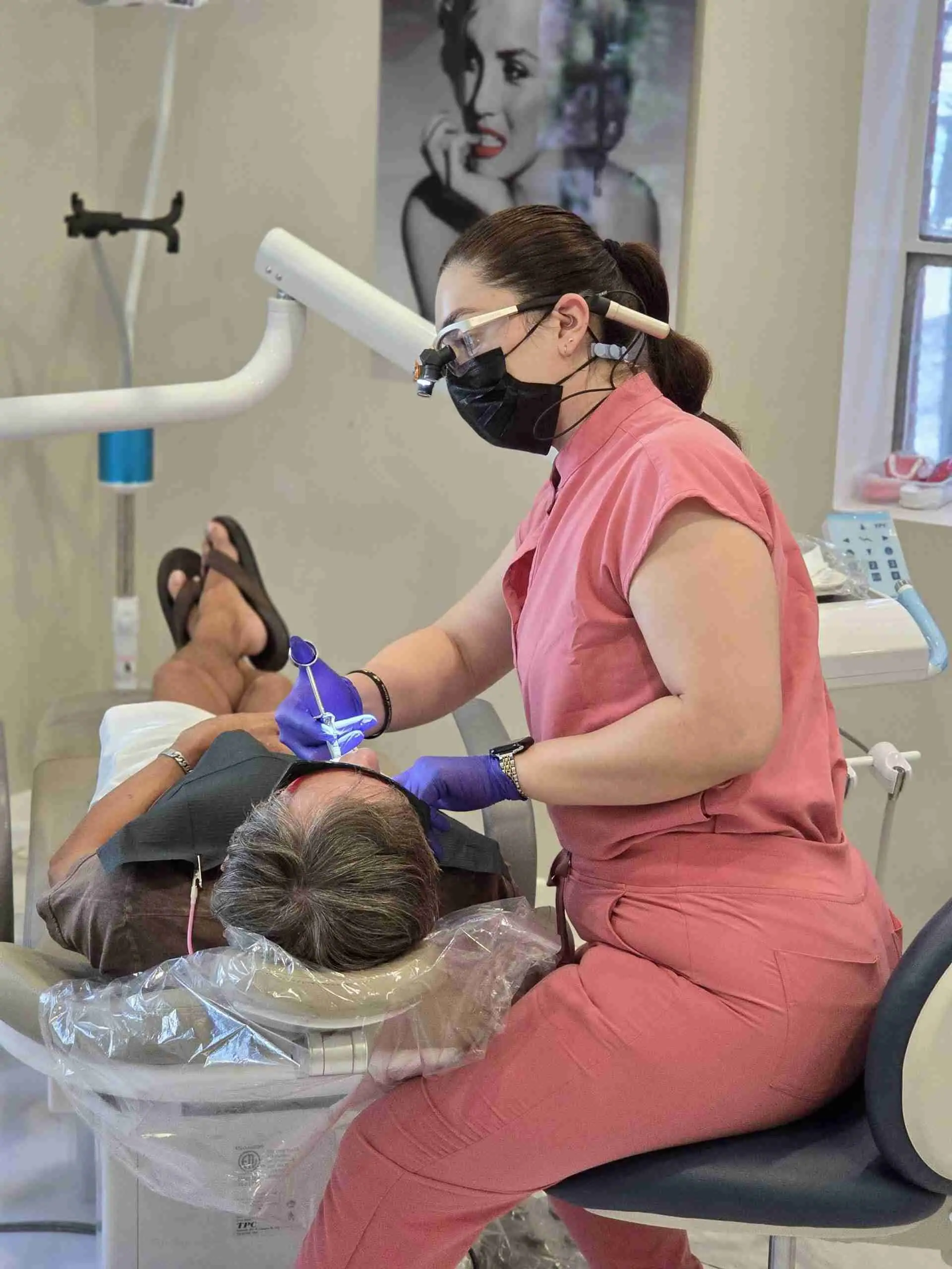 Clinician treating a patient in the dental chair